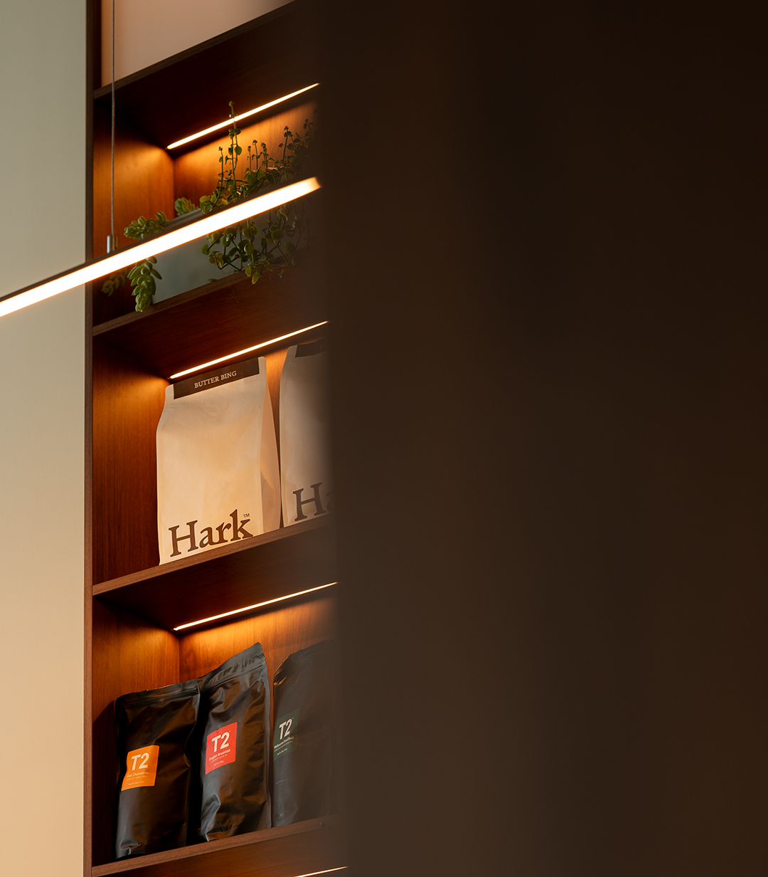 Bags of Hark coffee lined along the shelf behind the counter at Snow Bean.