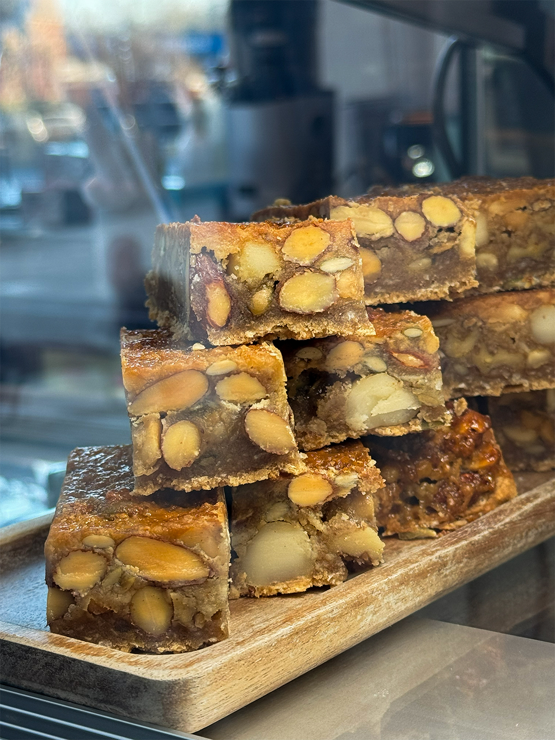 A tray of house-made nut and oat crackers, cut into bars.